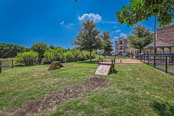 a dog park with benches and a chain link fence at Discovery at Craig Ranch, McKinney, 75070